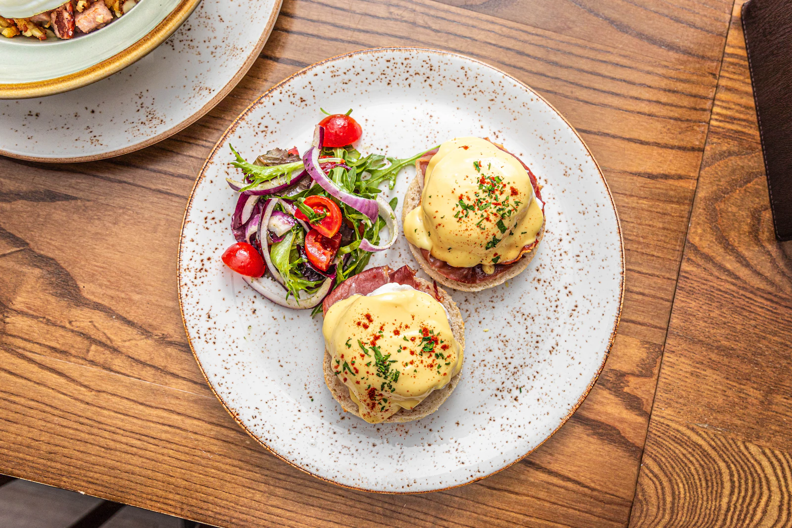 Eggs Benedict auf einem Holztisch
